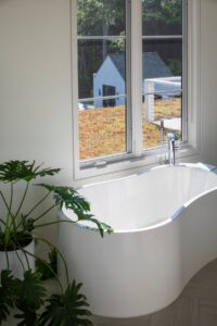 Bathtub with view of sedum roof