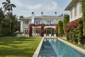 Exterior loggia with pink flowers, outdoor deck, and pool