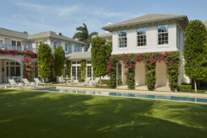 Exterior loggia with pink flowers, outdoor deck, and pool