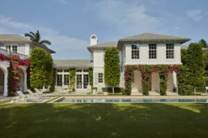 Exterior loggia with pink flowers, outdoor deck, and pool