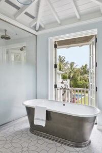 Primary bathroom with soaking tub and private shower and juliette balcony